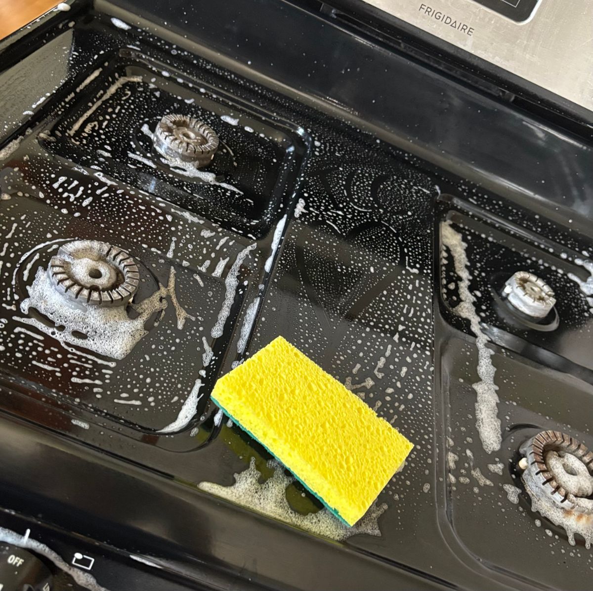 True Care Cleaning at work &mdash; a sudsy stovetop being cleaned